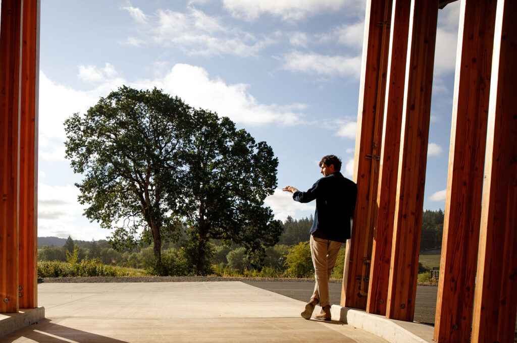 Alban leaning against building columns