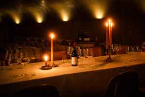 A table with candles in a wine cellar.
