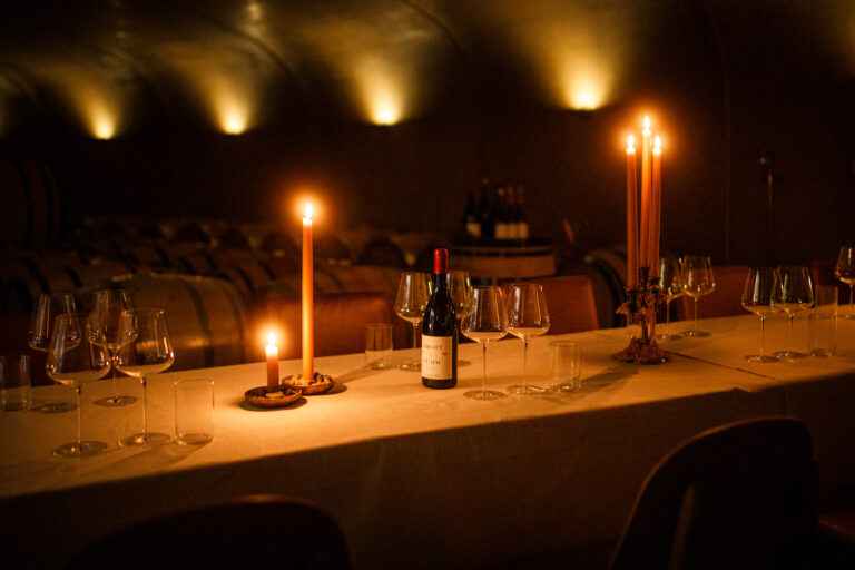 A table with candles in a wine cellar.